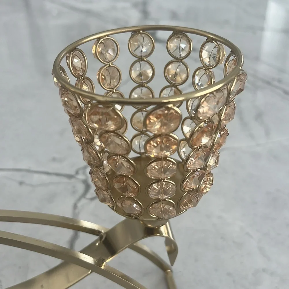 Elegant gold metal like candle holder with beautiful shiny crystal like gems